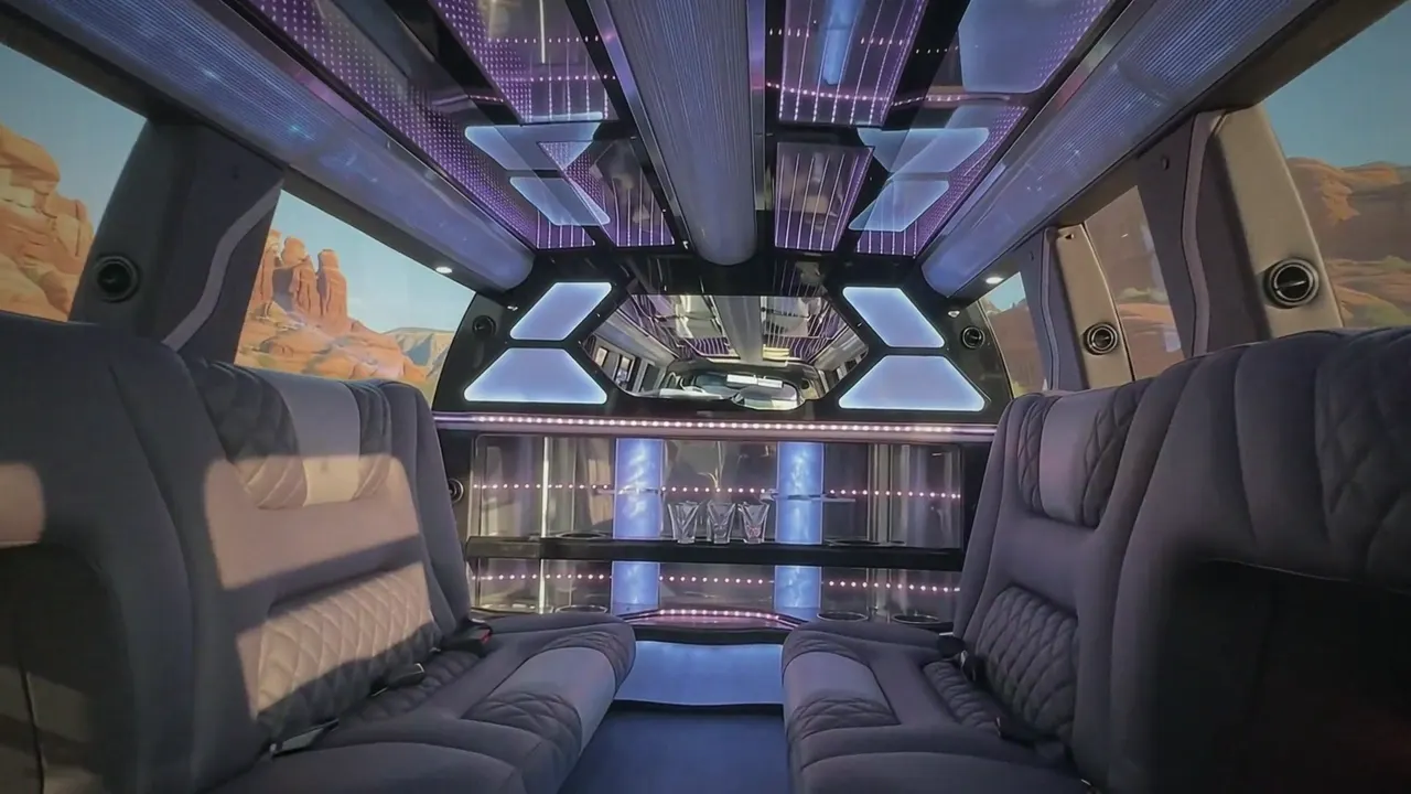 Inside the Cadillac Escalade limo in Vail: LED light-show ceiling, leather lounge seating and lit bar